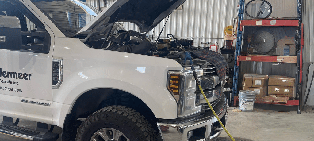 Ford truck maintenance and repair services in Palmerston, ON at CDP Diesel and Auto. Image of White Lariat F350 6.7L Powerstroke open hood park in the garage for Ford Truck Maintenance inspection in CDP Diesel and Auto.