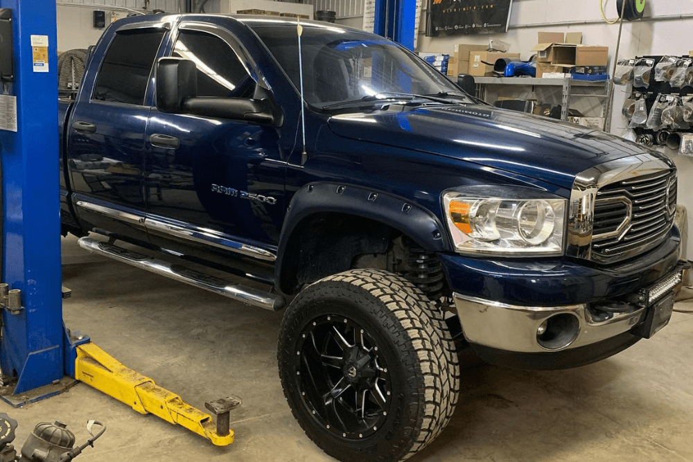 Diesel truck maintenance, diesel repair in Palmerston, ON by CDP Diesel & Auto. Image of a lifted Ram 2500 inside the shop. Highlighting CDP Diesel & Auto’s commitment to maintenance, durability, and customized diesel solutions.