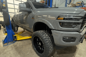Diesel truck owners, diesel repair in Palmerston, ON, at CDP Diesel & Auto INC. Lifted Ram heavy-duty diesel truck in a professional repair shop, highlighting expert diesel truck maintenance, suspension upgrades, tire services, and performance repairs for work trucks and off-road vehicles.